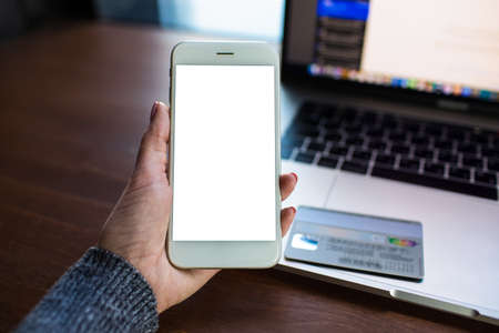 Closely business woman online booking via mobile phone with empty mock up copy space screen...