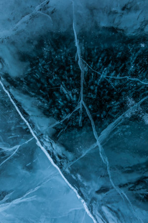 Top views of a texture cracks transparent ice on a Baikal lake on a snowy winter day. Natural backgroundの写真素材