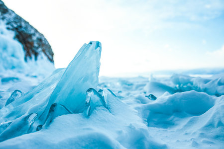 Beautiful view of a small cracked ice floe on frozen Baikal lake in evening timeの写真素材