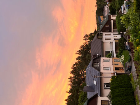 Sunset in the village overlooking the European houses and the forest. Modern private houses. Living in the middle of natureの写真素材