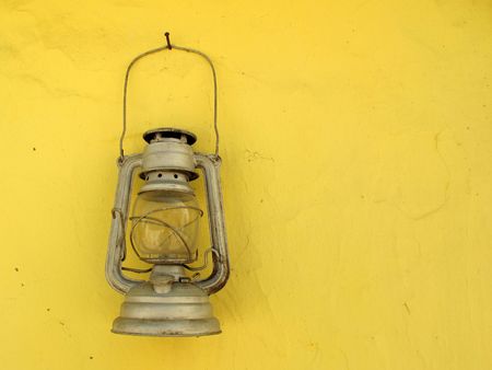 Lantern old vintage hanging on yellow wall の写真素材