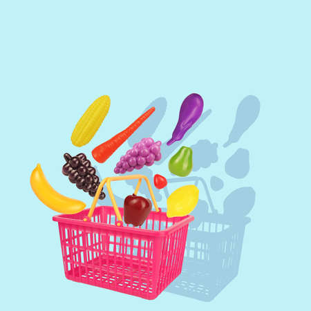 Pink yellow shopping basket with fruits and vegetables buying concept isolated on white backgroundの写真素材