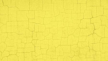 Textured cracked pastel yellow wall vivid backgroundの写真素材