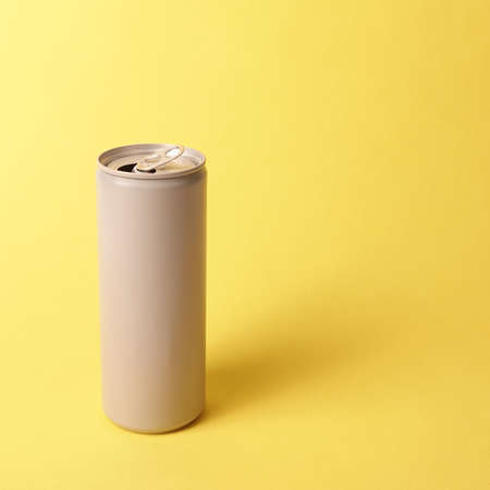 Gray grey can drink beverage juice on yellow background concept minimal aestheticの写真素材