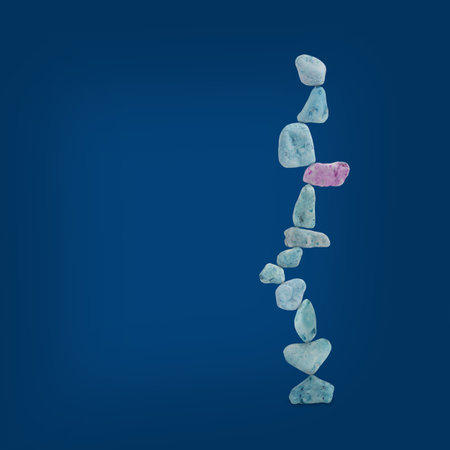 Modern art stones are balancing on dark blue background. Minimal concept balance photo. Abstract shape and lightの写真素材