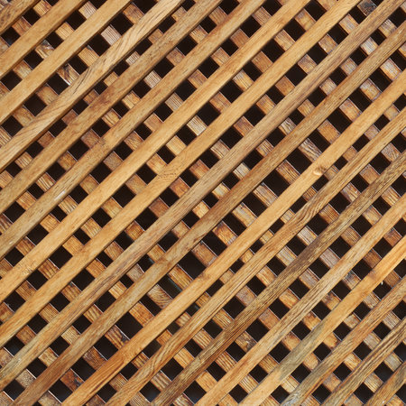 Cross brown wooden boards beds or bars on wall or fenceの写真素材
