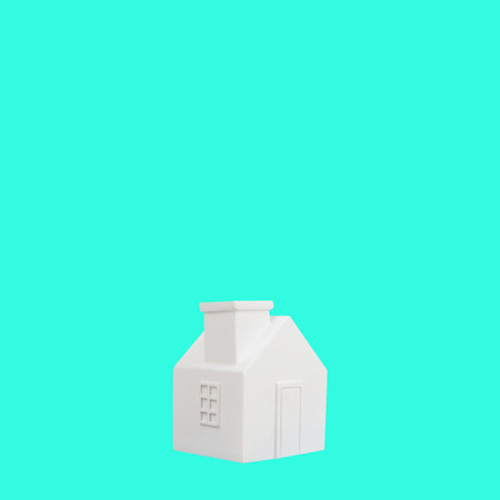White house home on turquoise background. Copy space minimal conceptの写真素材