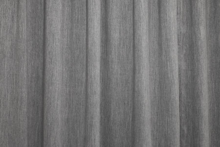 Beautiful simple gray curtain with folds ripples background. Heavy grey drape window cover interior backdropの写真素材