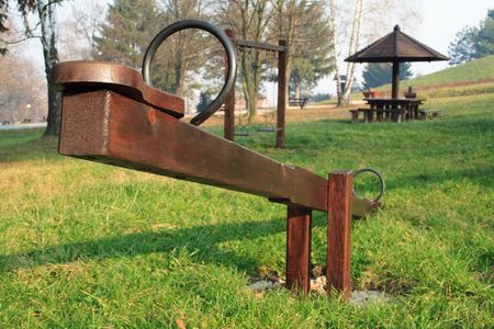 A wooden seesaw in a park の写真素材