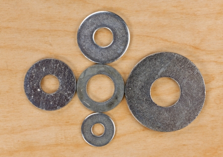 washers on the wooden board closeup