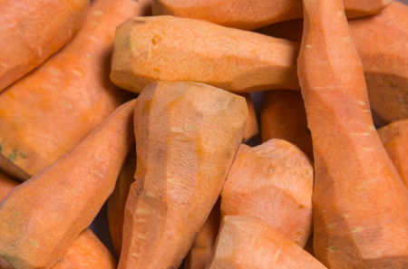 peeled carrots close-up as backgroundの写真素材