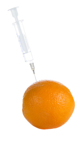 orange with syringe on white backgroundの写真素材