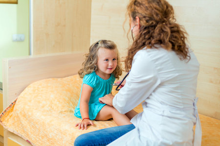 young doctor examining a childの写真素材