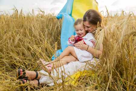 Woman with child at the wheat fieldの写真素材