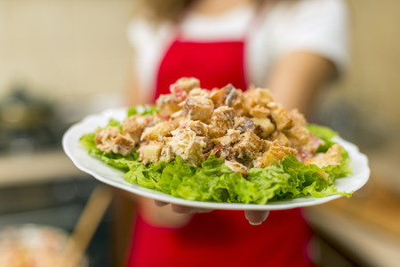 plate of food in the girl's handの写真素材