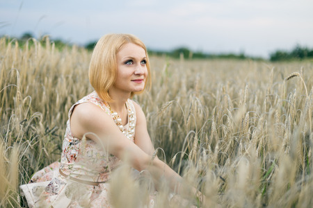 beautiful girl in a wheat fieldの写真素材