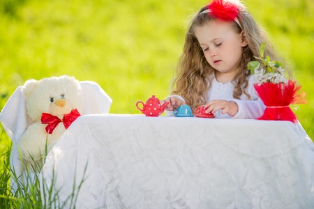 child in the garden drinking teaの写真素材