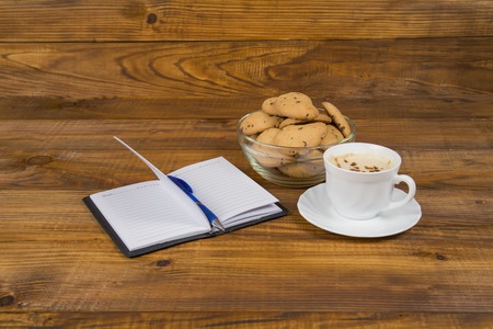 notes of coffee and cookies on the wooden tableの写真素材
