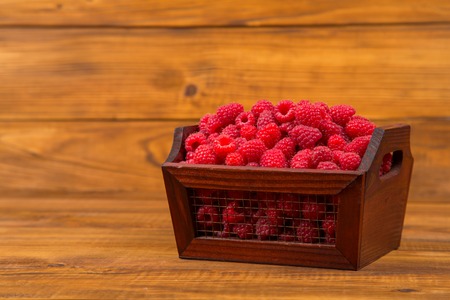 box of raspberries on wooden tableの写真素材