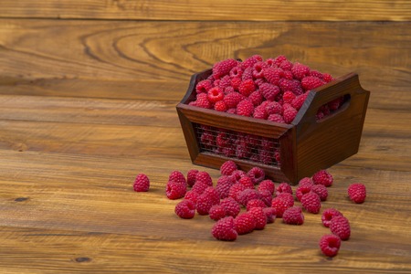 box of raspberries on wooden tableの写真素材