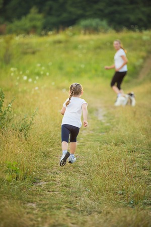 child with mother run in natureの写真素材
