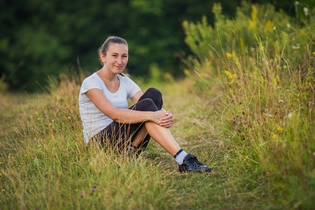 girl sitting in the grassの写真素材