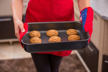 tray of homemade cookies in the hands of womenの写真素材