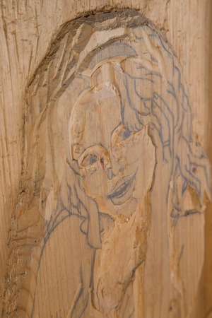 Girl portrait carved in woodの写真素材