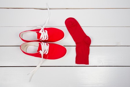 red shoes with white socks wooden tableの写真素材