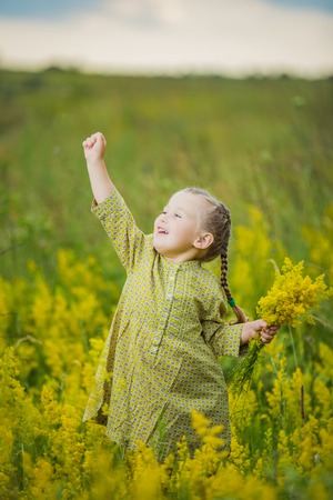 baby with a wreath of yellow flowersの写真素材