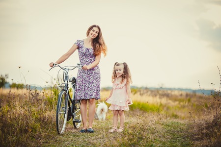 mother with her baby and a bike ride in natureの写真素材
