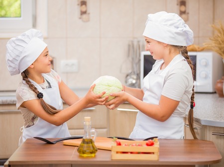 two women chefs share cabbageの写真素材