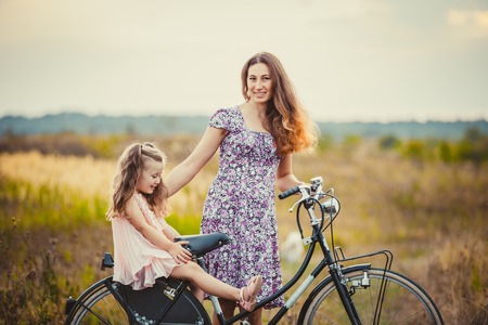 mother with her baby and a bike ride in natureの写真素材