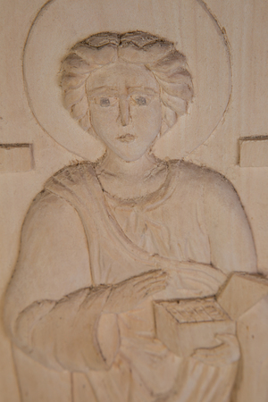 Orthodox saints carved out of wood closeup as backgroundの写真素材