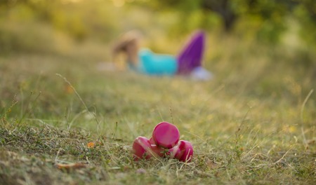 red dumbbells in the summer parkの写真素材