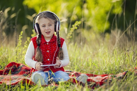 girl with white headphones on natureの写真素材