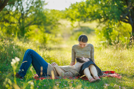 Happy couple sitting in natureの写真素材