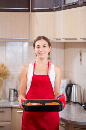 Portrait of a young woman in the kitchenの写真素材
