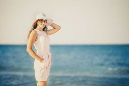 girl in a hat on the background of the seaの写真素材