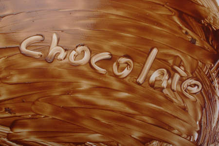 written on a background of chocolate chocolateの写真素材