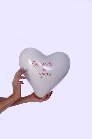 hands and balloons in the shape of a heart   my heart is yours 