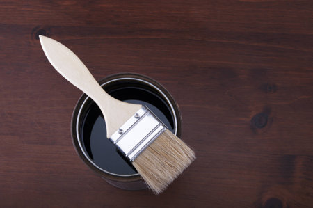 paint can with brush on wooden boardの写真素材