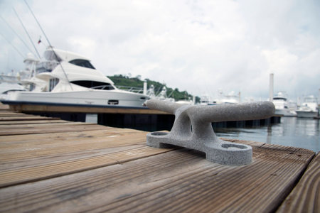 mooring bollard with boats in the backgroundの写真素材