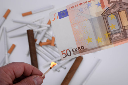 Flame and euro with cigarettes and cigars backgroundの写真素材