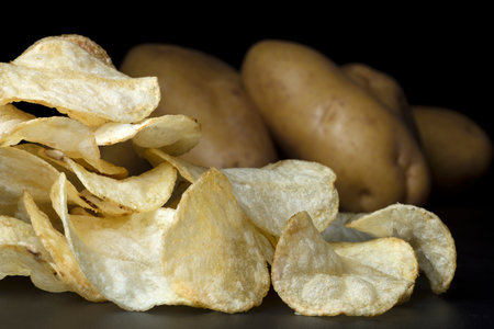 french fries with potatoes on background on black backgroundの写真素材