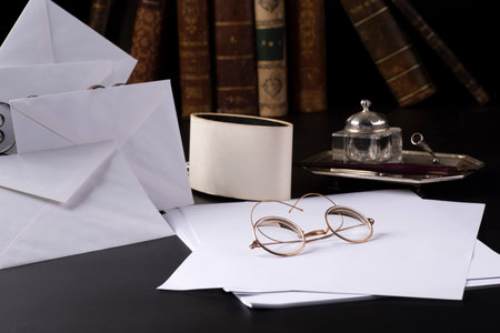 The work of a writer with pen and inkwell and sheets of paper, reading glasses, booksの写真素材