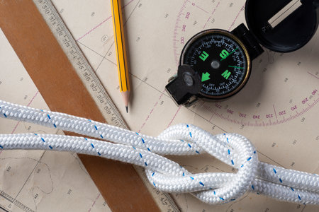 Compass, rope and compass on the background of a map.の写真素材