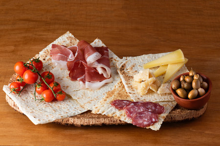 Italian antipasti with raw ham or jamon, parmesan cheese and olivesの写真素材
