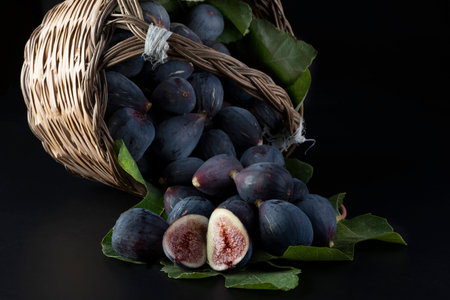 Fresh figs in a wicker basket on a black background.の写真素材