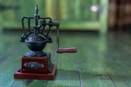 Retro coffee grinder on a wooden board